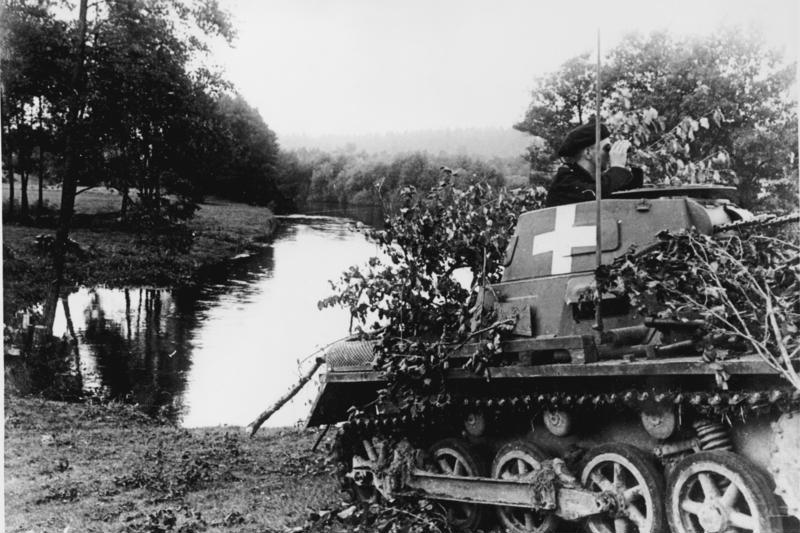 "German tank On the banks of the Brda river a German tank secures the area against attacks by scattered Polish troop units. The commander tensely observes the terrain with field glasses, to be able to immediately open fi