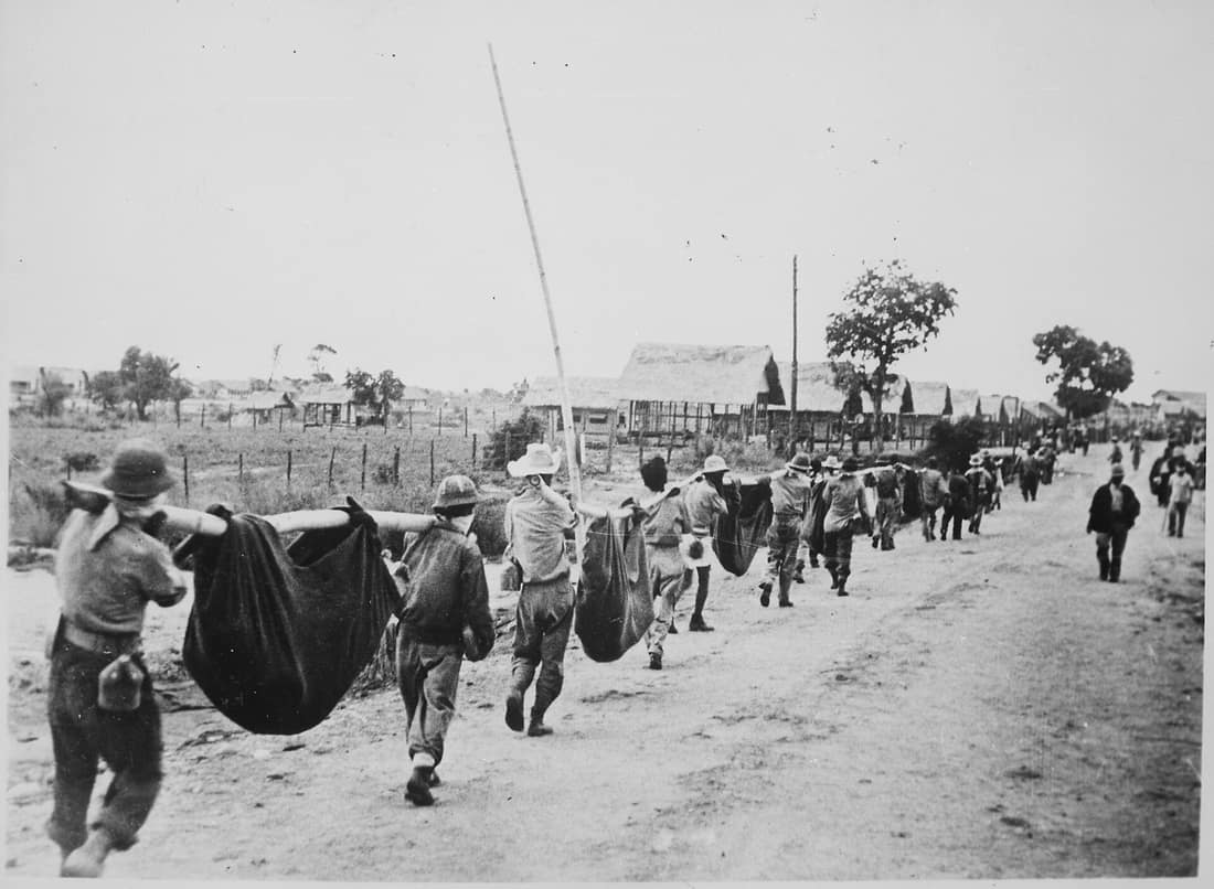 Scope and content: Original caption: This picture, captured from the Japanese, shows American prisoners using improvised litters to carry those of their comrades who, from the lack of food or water on the march from Bata