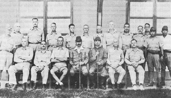 American generals in captivity, July 1942. Seated, left to right: Generals Moore, King, and Wainwright; Lt. Col. Ito, camp commandant; Japanese lieutenant; Generals Parker and Jones. Standing, left to right: Japanese mes