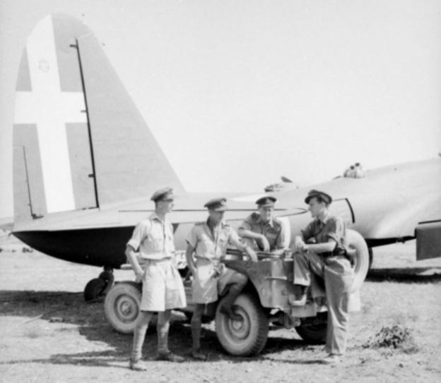 On Grottaglie airfield, Italy, pilots, Flight Lieutenant L. Wynne of Yorks, England, Squadron Leader Brian Eaton of Melbourne, Vic, Flight Lieutenant Harris DFC of Adelaide, SA, talk to an Italian pilot who has just brou