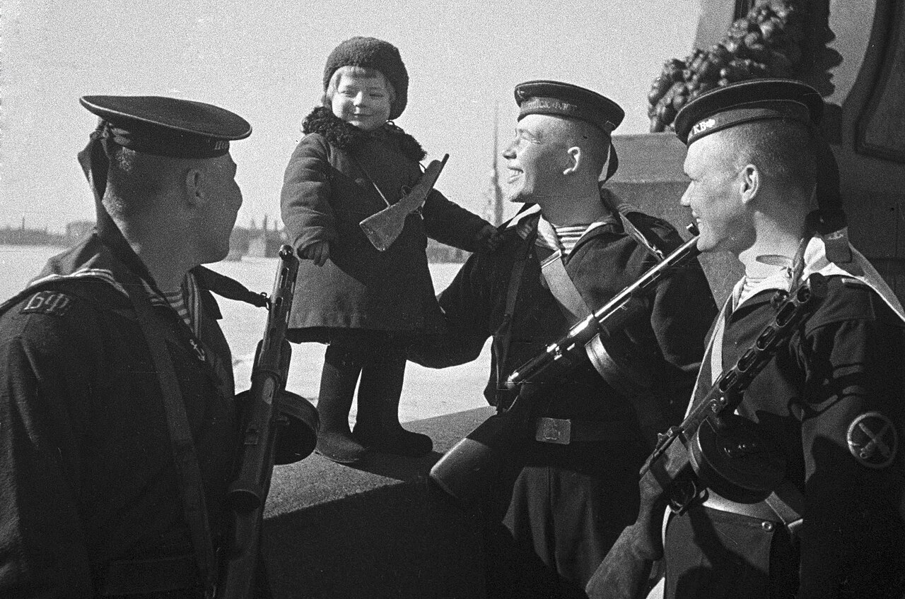 "Sailors of the Baltic Fleet are new parents of little girl Lucya" (short name of Lyudmila). Sailors of the Baltic Fleet with little girl Lucy whose parents died during the Siege of Leningrad.