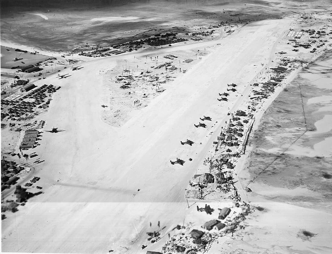 Aerial photograph of Hawkins Field, Betio Island, Tarawa Atoll, Gilbert Islands in March 1944. Visible on the airfield runways are a Douglas R4D, two Consolidated PBY-5A Catalinas, and several Lockheed PV-1 Venturas. Ele