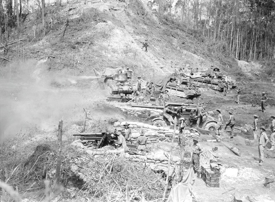 25-pounder artillery pieces from the 2/7th Field Regiment fire along with Matilda tanks from the 2/9th Armoured Regiment and an anti-aircraft gun from the 132nd Anti-Aircraft Battery, Tarakan, June 1945.