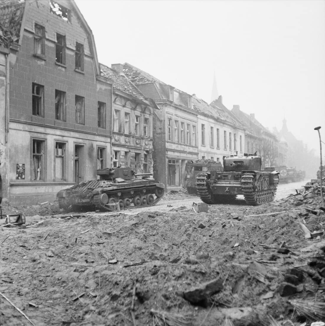 The British Army in North-west Europe 1944-45 A Churchill tank and a Valentine Mk XI Royal Artillery OP tank (left) in Goch, 21 February 1945.