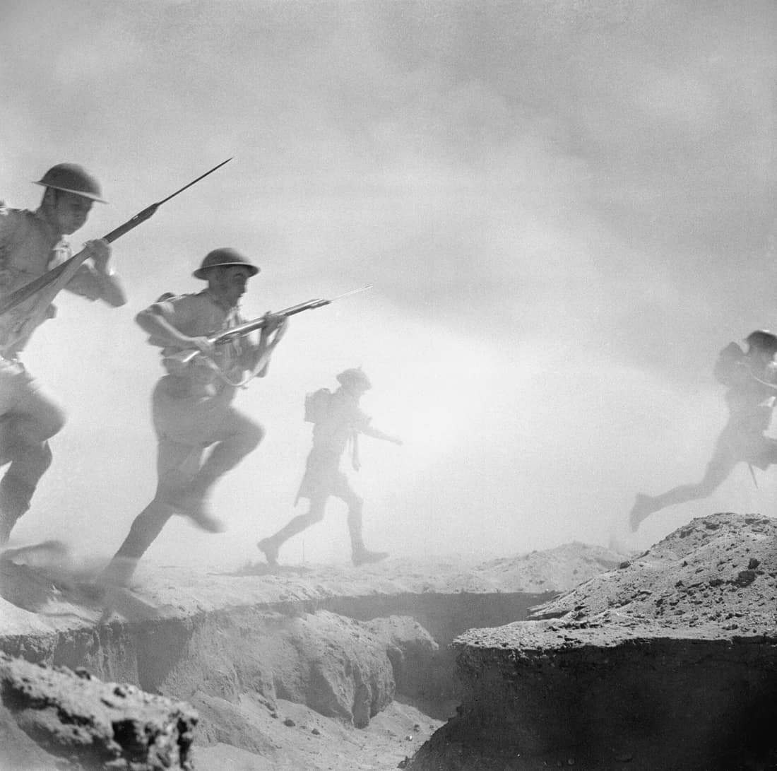 El Alamein 1942: British infantry advances through the dust and smoke of the battle. Sergeant Len Chetwyn had a focus on creating and recording re-enactments of military scenes behind the front lines rather than recordin