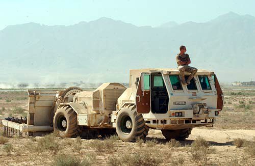 Spc. Adam Augusta, from the U.S. Army’s 769th Engineers from Louisiana, waits for further instructions over the radio for clearing dangerous areas with the Hydrema mine clearing vehicle at Bagram Air Base in Afghanistan.
