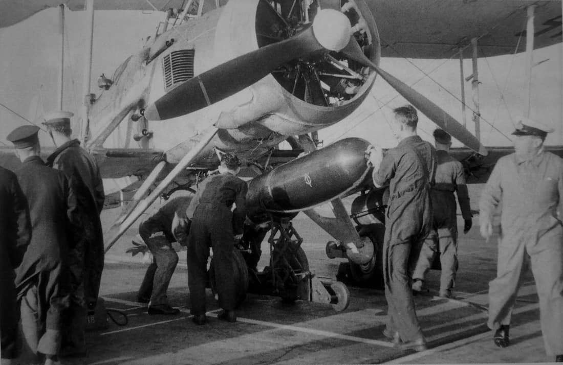 Fairey Swordfish being loaded with a torpedo on the deck of HMS Ark Royal (91) in 1941.