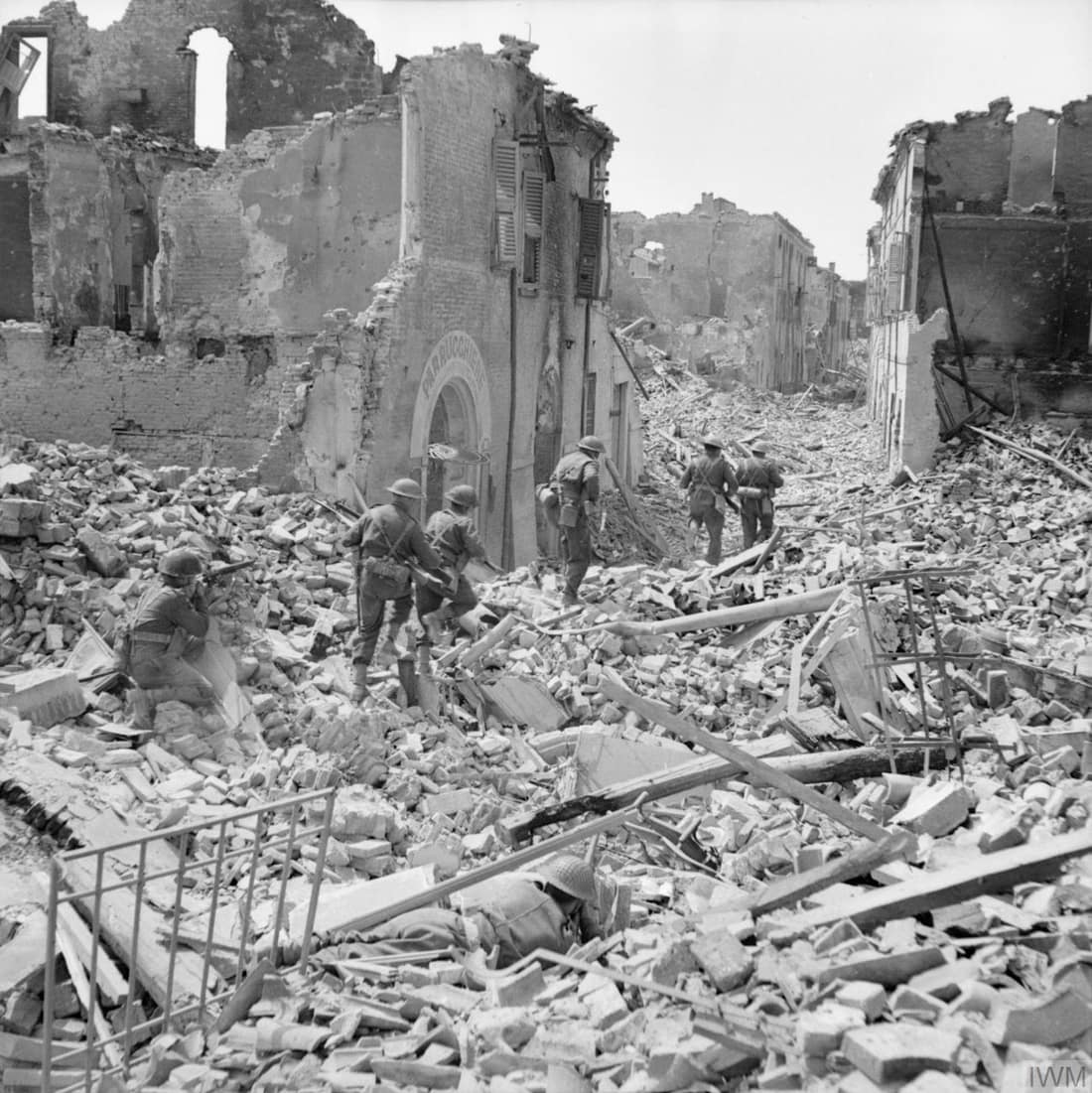 The British Army in Italy 1945 Men of the 5th Northamptonshire Regiment pick their way through the ruins of Argenta, 18 April 1945.