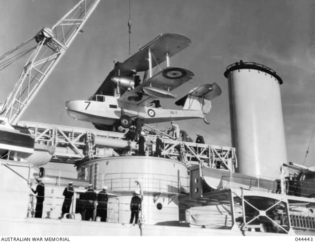 A Supermarine Seagull V amphibian aircraft, serial number A2-7, of No. 9 (Fleet Cooperation) Squadron RAAF embarked on the modified Leander class cruiser HMAS Hobart of the RAN being positioned on the catapult fitted to 