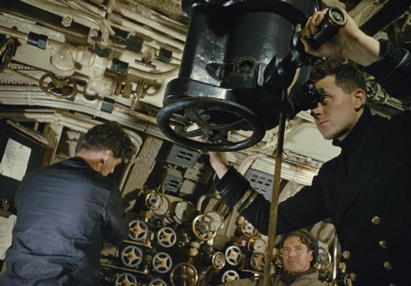 On Board Hm Submarine Tribune, 1942 The First Lieutenant, Lieutenant R Bulkeley at the forward periscope of HMS TRIBUNE, with a stoker working the periscope operating handle and an Engine Room Artificer responsible for t