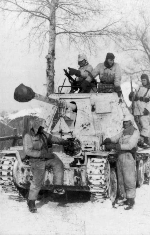 3rd Battle of Kharkov, February 1943. Men of 1 Panzer Regiment of the Waffen-SS Division "Leibstandarte-SS Adolf Hitler" with a Marder III tank destroyer and infantry in snow camouflage overalls