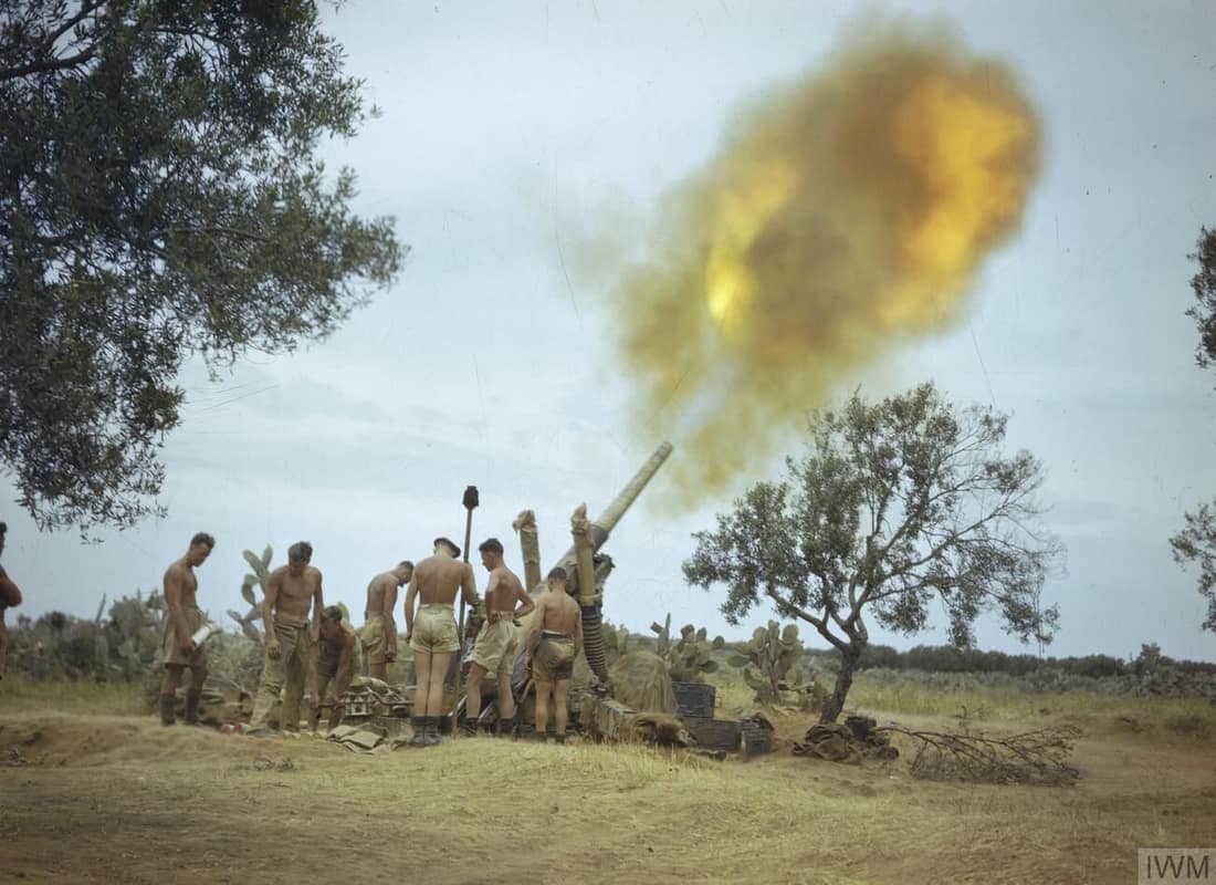 IWM caption : COLLABORATION OF ROYAL AIR FORCE SPITFIRES AND THE EIGHTH ARMY, TUNISIA, SPRING 1943. The gunnery officer has given the range to No 1 at the gun and the 4.5 inch gun fires on the target. This picture was ta