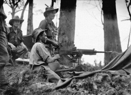 Soldiers from the 2/2nd Machine Gun company using a captured Japanese 7.7mm machine gun to attack Japanese positions on Joyce Feature, Tarakan.