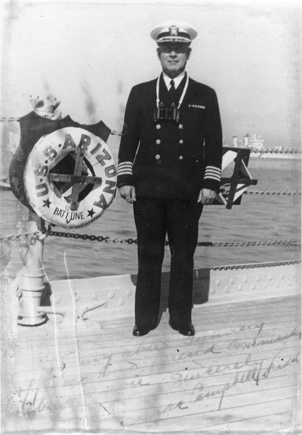 Photograph of Captain Isaac C, Kidd, USN, Commanding Officer, USS Arizona (BB-39) Photographed on the deck of his ship, circa 1939. Captain Kidd has inscribed the original print: To my able gunnery officer and friend Com