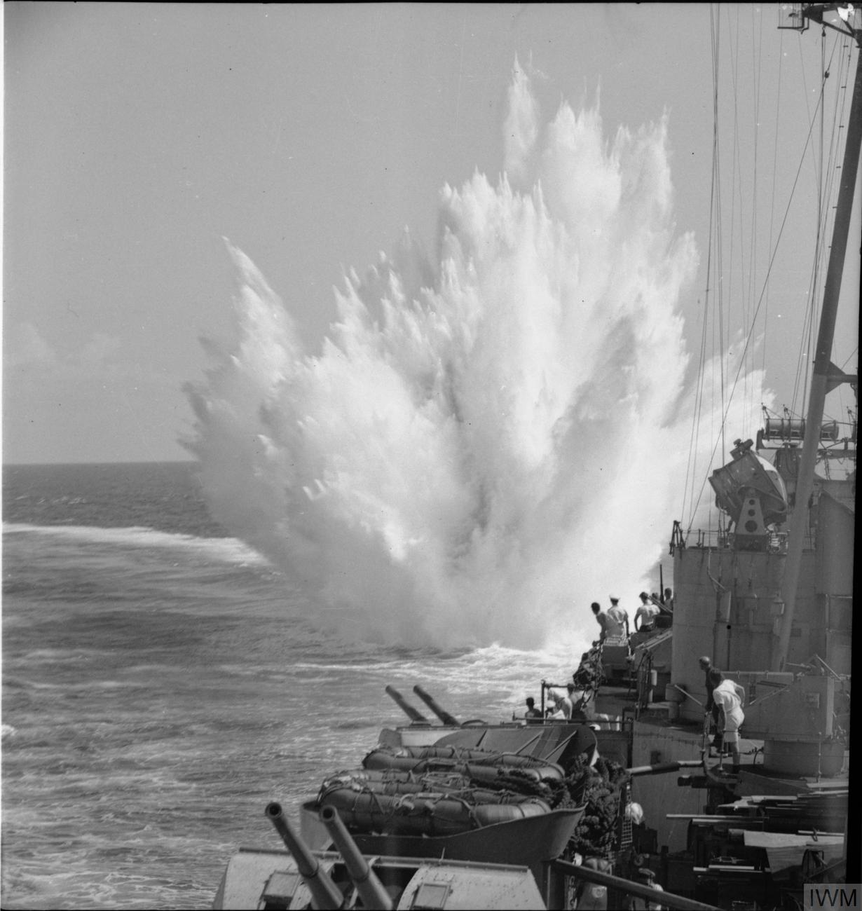IWM caption : A depth charge explodes after it had been dropped from HMS CEYLON. The ship had just made a call at Colombo the capital of Ceylon.
