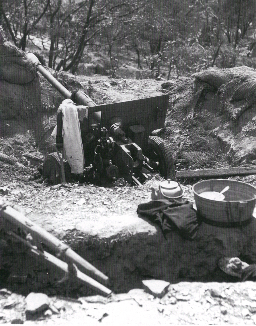 An abandoned Soviet-made North Korean 76 mm divisional gun M1942 (ZiS-3) captured by United Nations forces on a hill overlooking Incheon, South Korea, after the amphibious landings at Incheon during the Korean War.